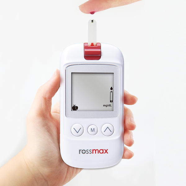 A lady checking here blood glucose levels with the Rossmax blood glucose monitor 