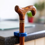 A cane is placed on a counter, highlighting the STIC® accessory for easy hanging and magnetization when not in use.